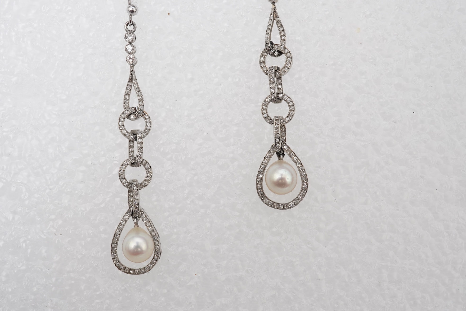 Attributed to Maurice Robin & Cie, a fine and rare pair of Art Deco natural pearl and diamond earrings, Paris, circa 1920